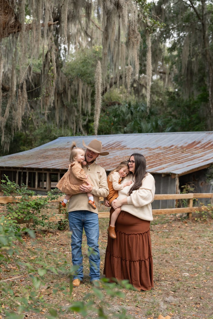 Family photo session by the historic red barn at Alpine Groves Park, Fruit Cove FL