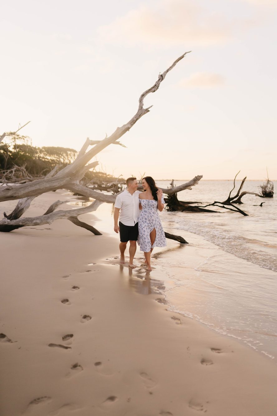 Couple dip kissing on the black rock formations with tide pool reflections at Black Rock Beach, Big Talbot Island