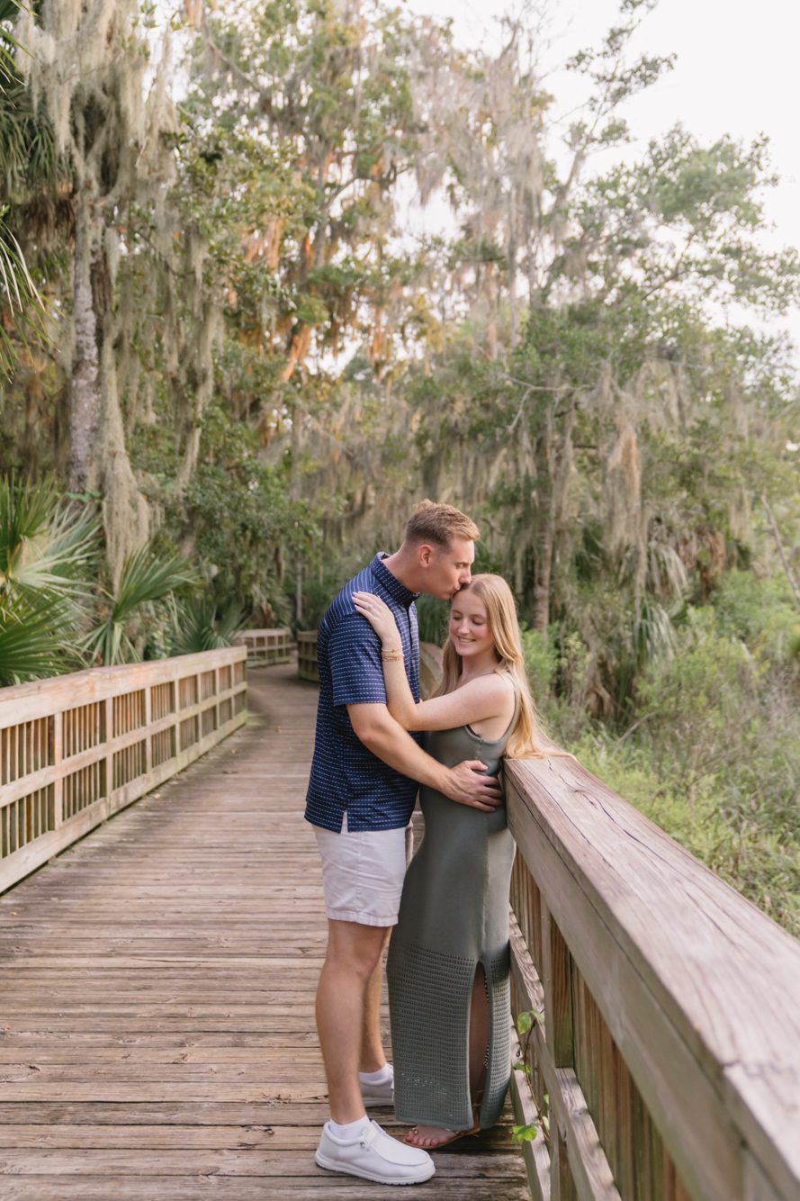Bride and groom on the boardwalk among Spanish moss and palms at Cradle Creek Preserve, Jacksonville Beach FL by Lee Photo + Video