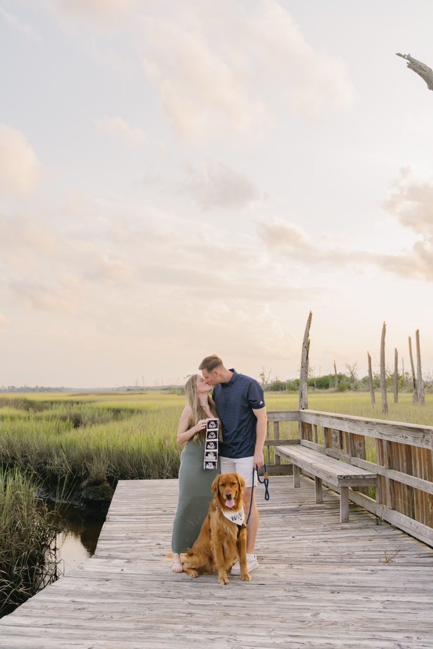 Couple embracing on the elevated boardwalk beneath mossy oaks at Cradle Creek Preserve, Jacksonville Beach