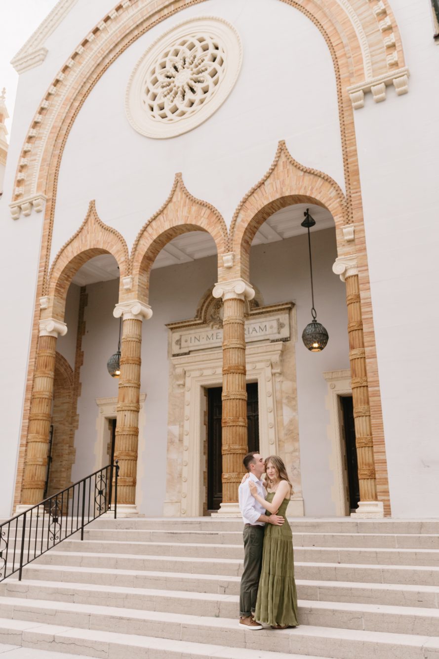 Bride and groom kissing on the Bridge of Lions at sunset with the historic St. Augustine skyline by Lee Photo + Video
