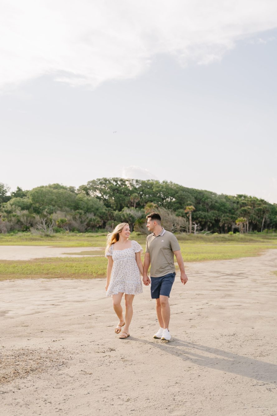 Couple embracing on the grassy shoreline of Fort George Inlet on Jacksonville's Northside by Lee Photo + Video