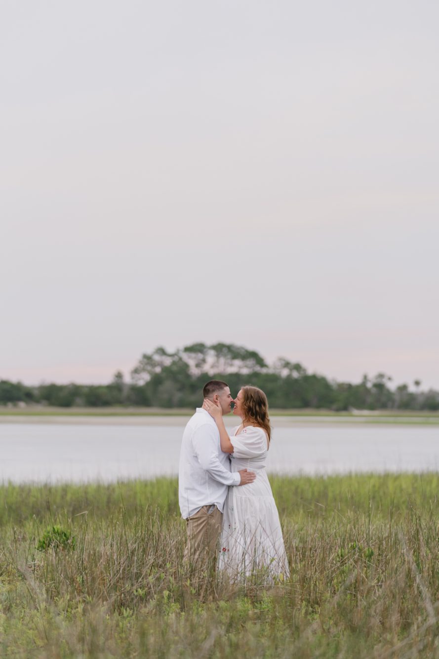 Couple holding hands walking the wide open sand flats at Fort George Inlet, Jacksonville FL
