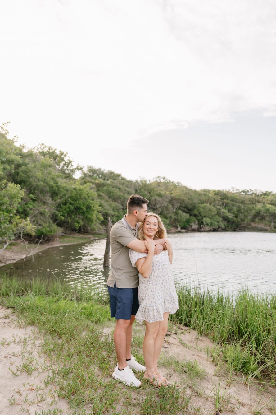 Couple nose to nose in the golden marsh grass at sunset, Fort George Inlet on Fort George Island by Lee Photo + Video