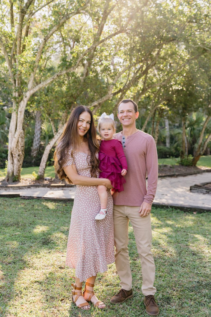 Family of four on the wooden footbridge surrounded by palms at Howell Park in Atlantic Beach FL by Lee Photo + Video