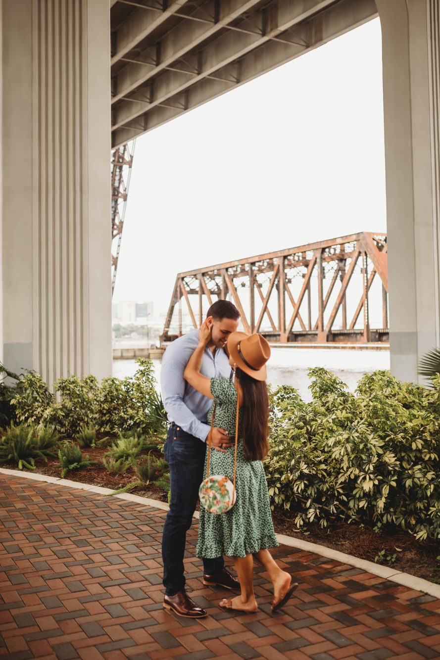 Couple adding a padlock to the love locks fence on the Lock Bridge in downtown Jacksonville by Lee Photo + Video