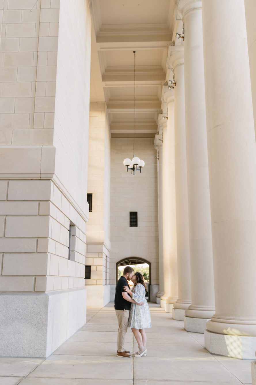 Couple kissing in the grand colonnade of the Prime Osborn Convention Center, Jacksonville FL by Lee Photo + Video