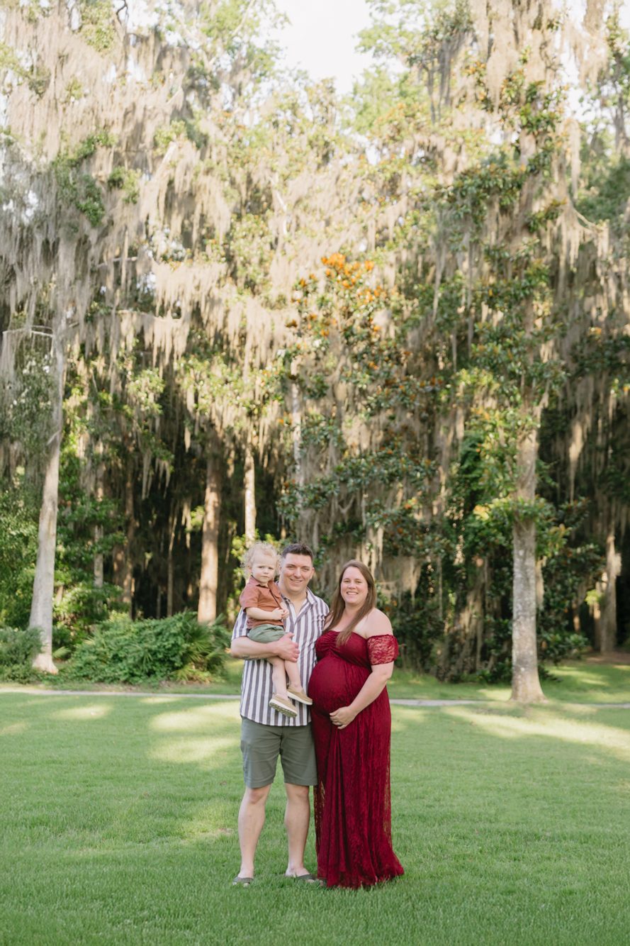Expecting parents on the open lawn framed by magnolias and Spanish moss at Riverfront Park, St. Johns Florida