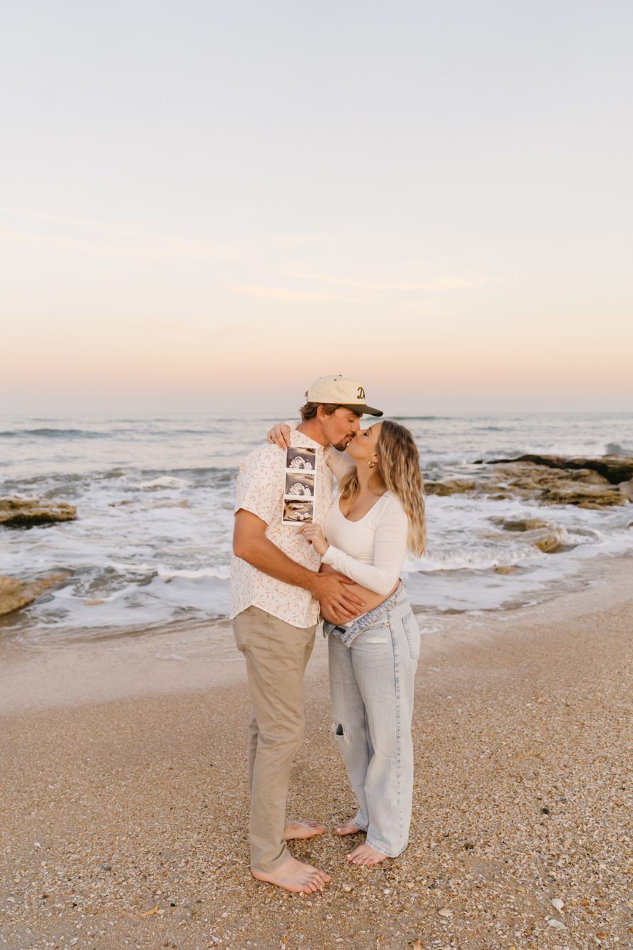 Engagement photos among the tan rocks of Washington Oaks Beach by Lee Photo + Video