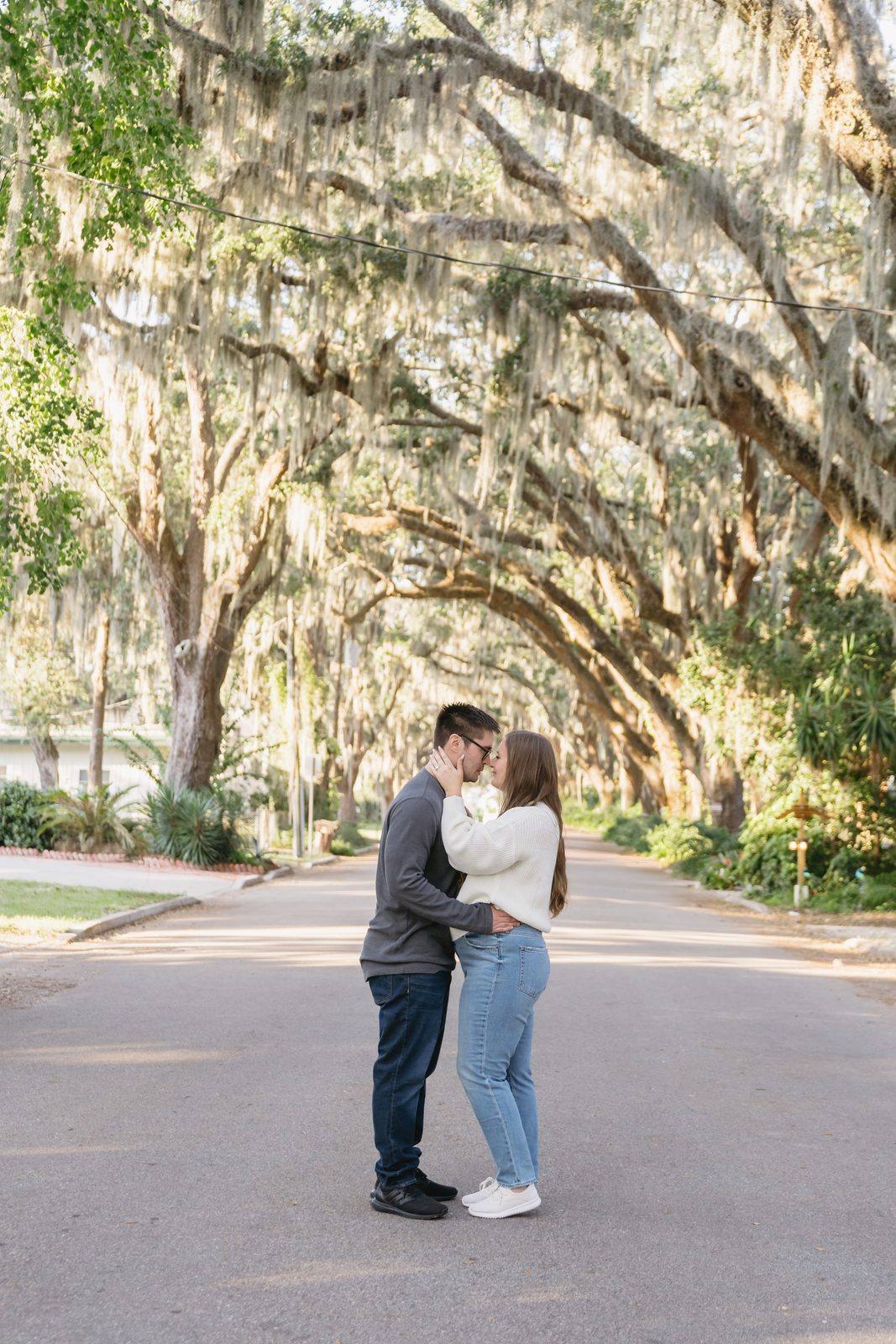 A couple kissing under the oak canopy on Magnolia Avenue in St. Augustine