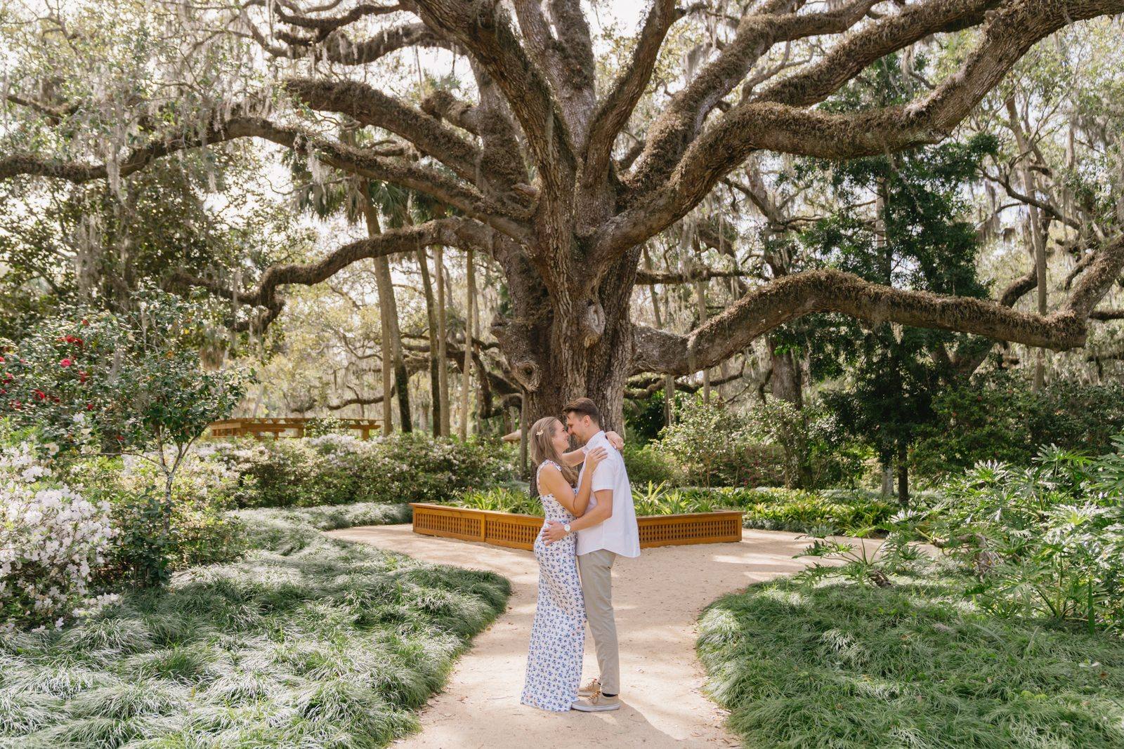 A couple beneath the grand oak in the gardens at Washington Oaks Gardens in Palm Coast