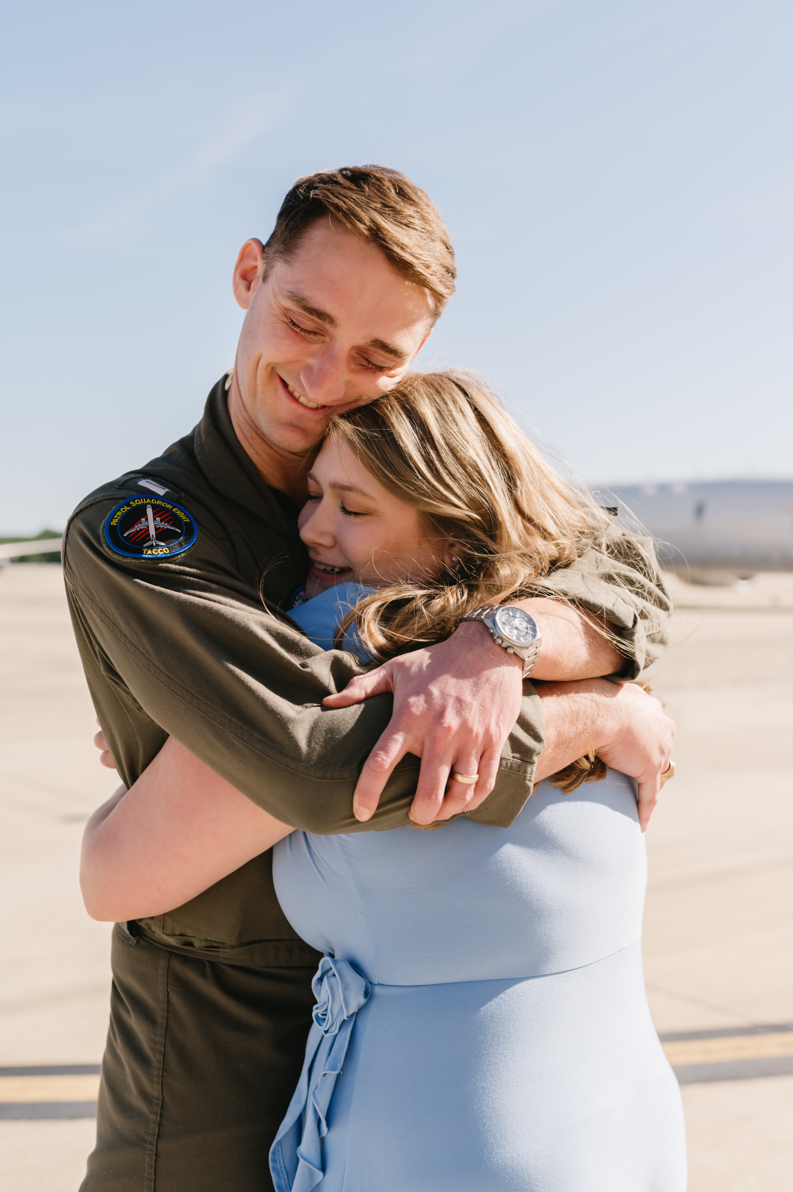 Navy officer kissing spouse in front of destroyer at Mayport Naval Station homecoming