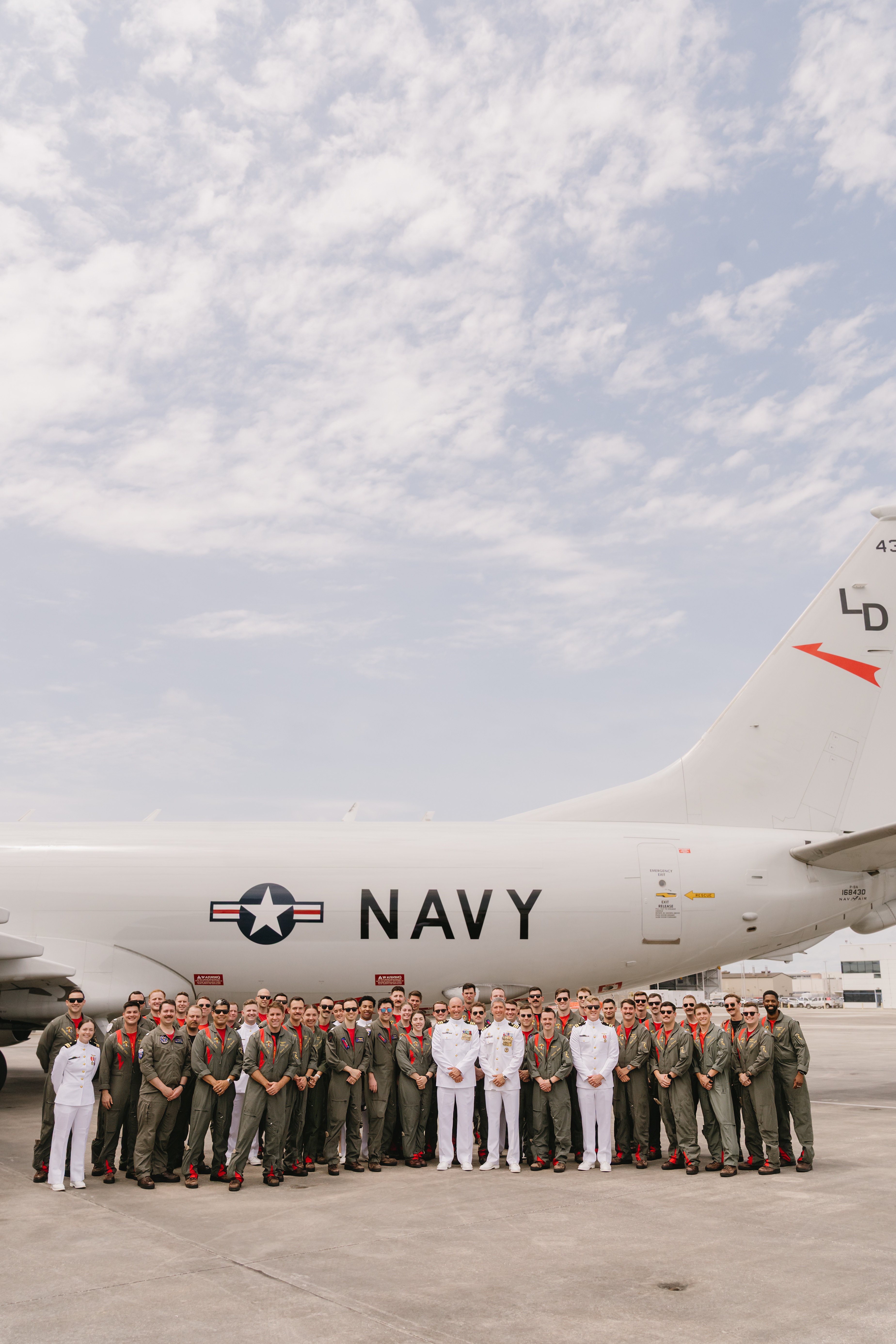 Navy squadron group photo in front of P-8 Poseidon aircraft at NAS Jacksonville