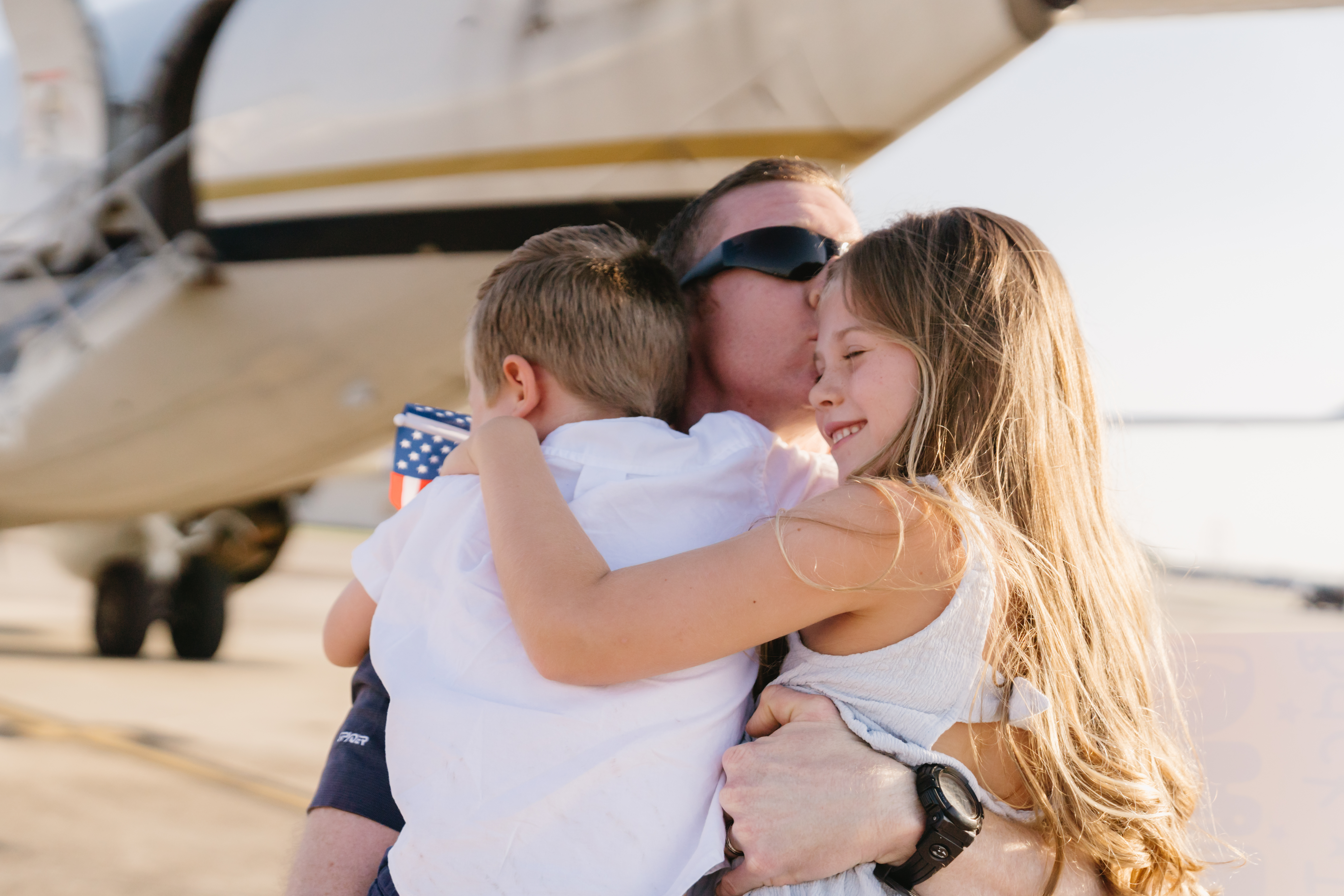 Military couple portrait in front of Navy P-8 aircraft on flight line