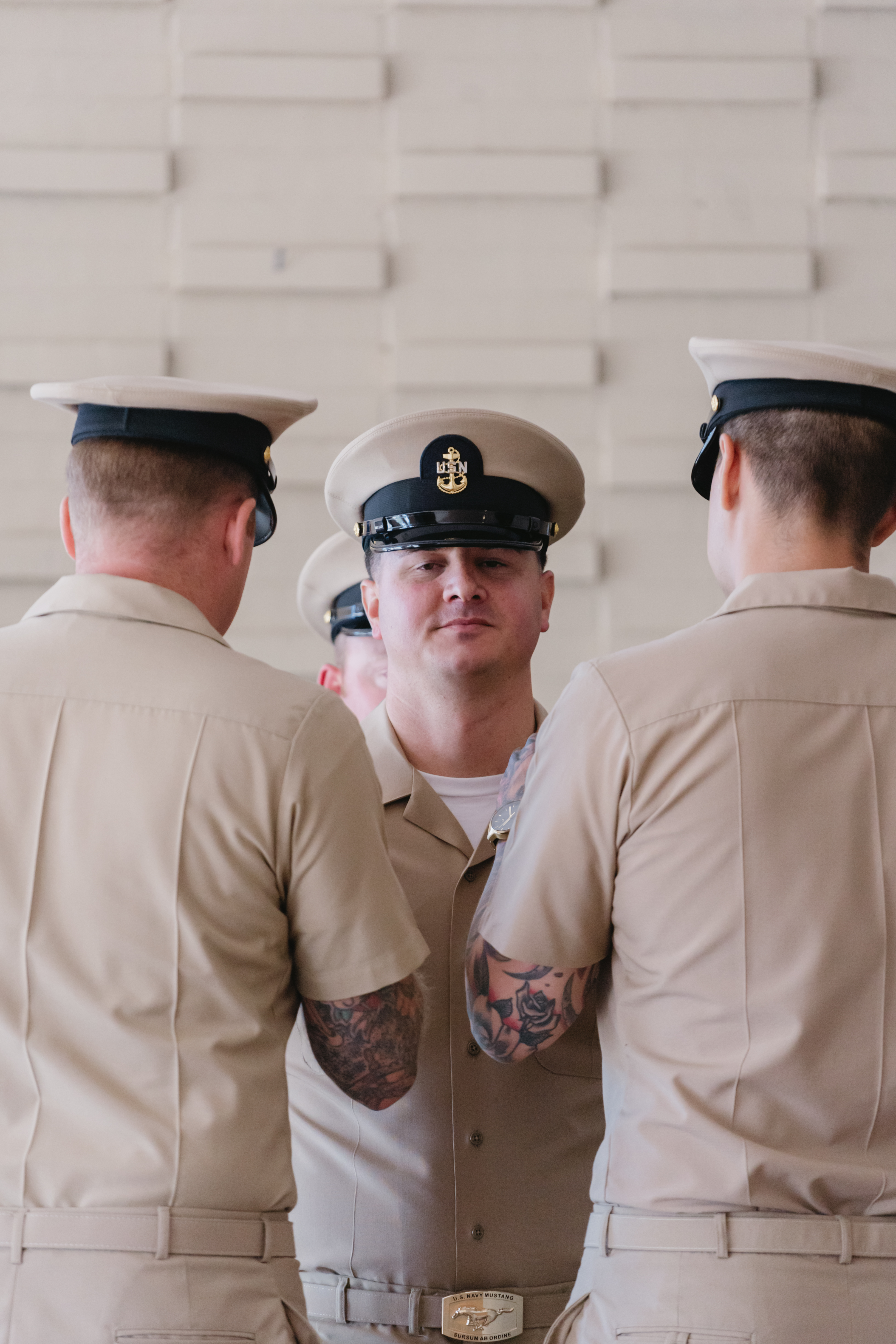 Navy spouse pinning medal on officer during promotion ceremony at Mayport